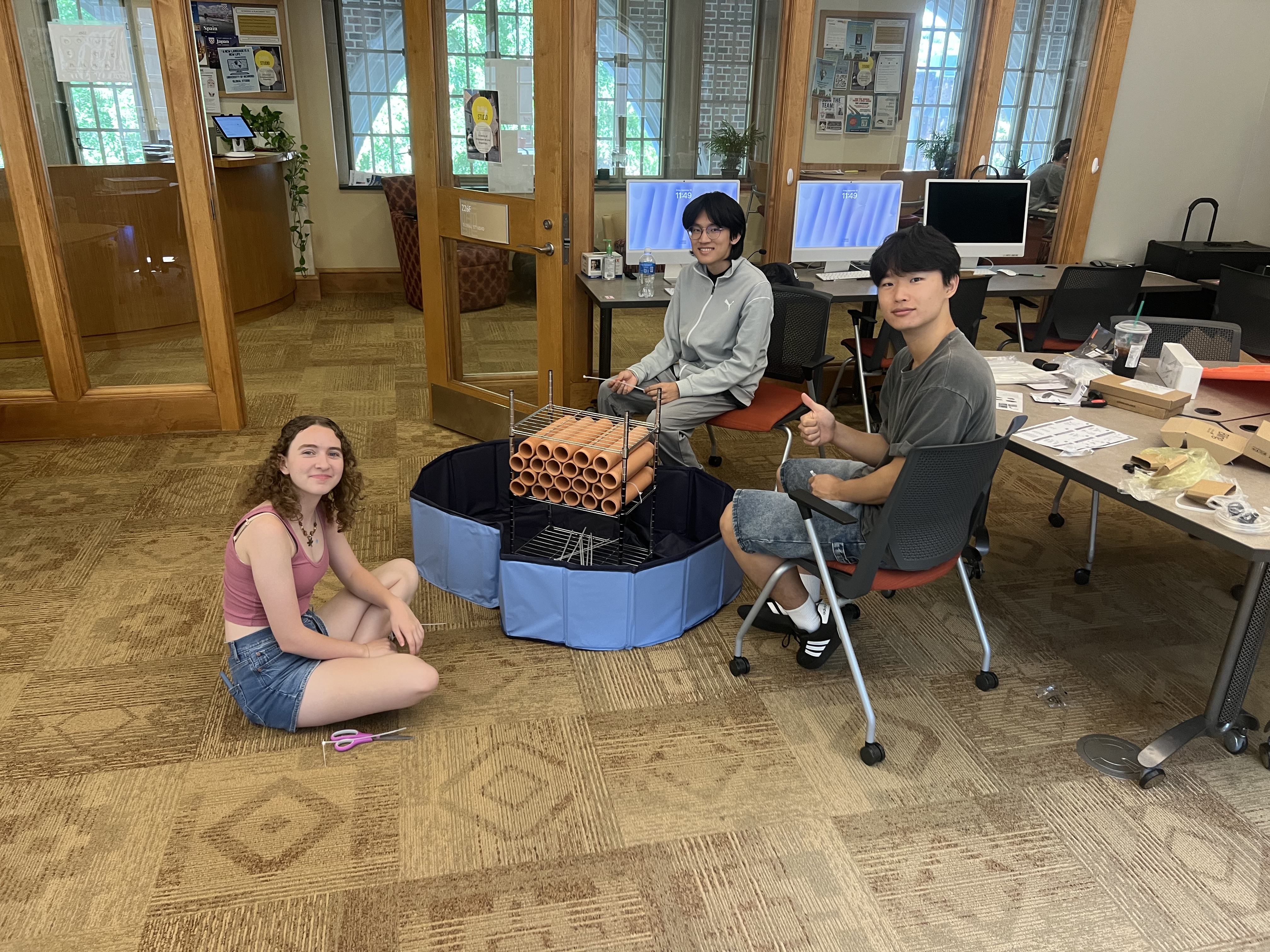 Team assembling terra-cotta pipe prototype